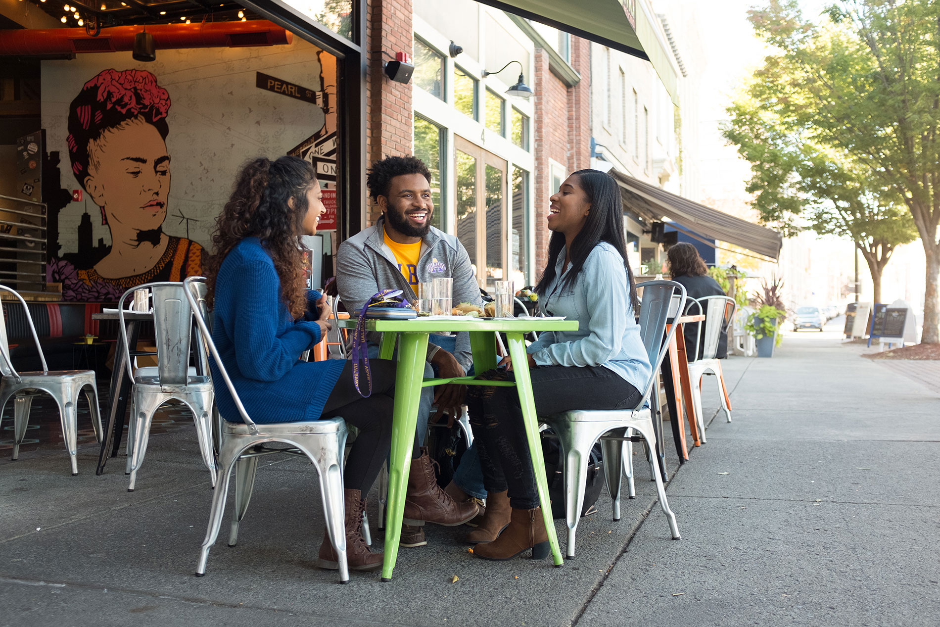 Three students eating together in downtown Albany